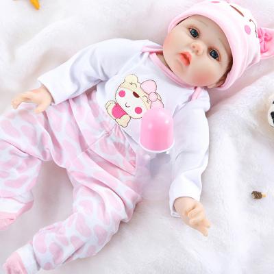 China Lovely Baby Doll Toys 23 Inch 58cm Silicone Baby Doll Cotton Reborn Body Cartoon With Long Black Straight Hair for sale