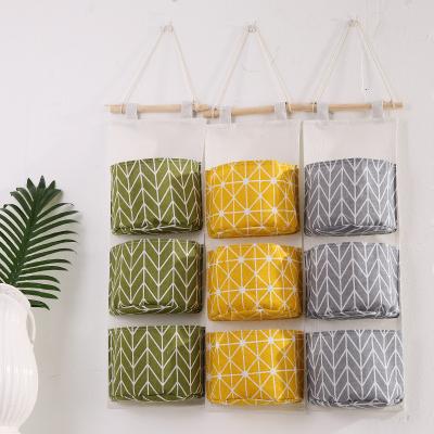 China Creative Cotton Folding Storage & Hanging Canvas Waterproof Bag 3 Layer Wall Hanging Sundries Storage Bag for sale