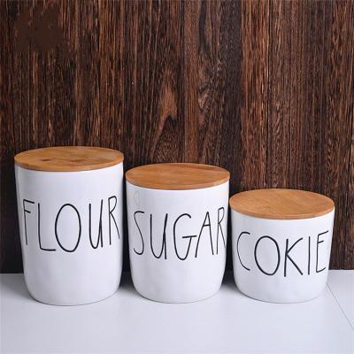 China Nordic Creative Multi Size Letter Printing Steamable Kitchen Tableware Food Container Storage Jar With Wooden Lid for sale