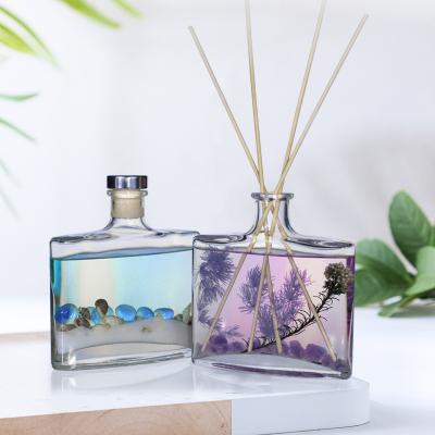 China Luxury Natural Glass Bottle Essential Oil Reed Diffuser With Natural Sticks For Gift Set Hourglass Shape for sale