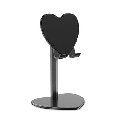 China New Design 2 PCS Phone Holder Tablet Desk Phone Magnetic Metal Heart Shaped Universal Lazy Retractable Stand for sale