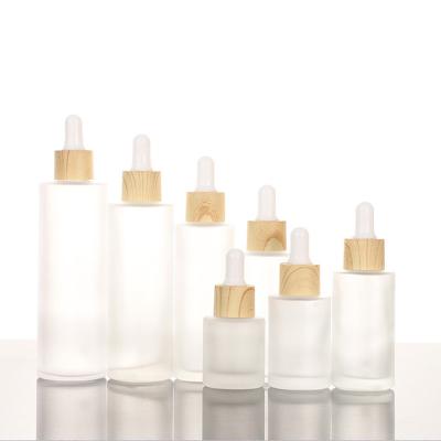 China Eco-friendly 1Oz 2Oz Custom Frosted Cosmetic Bottles Essential Oil To Serum Empty Dropper Glass Bottles With Bamboo Lids for sale