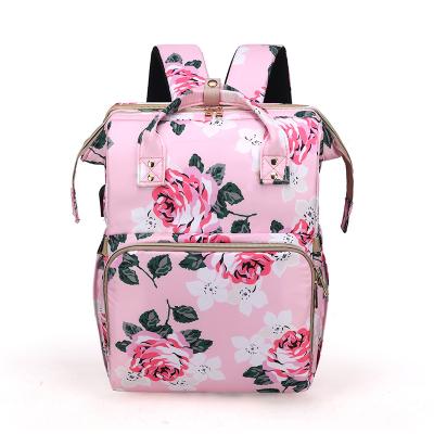 China Custom Water Resistant Shifang Flower Printed Shifang Fashion Diaper Backpack With Crib Mosquito Net Diaper Changing Folding Bag for sale