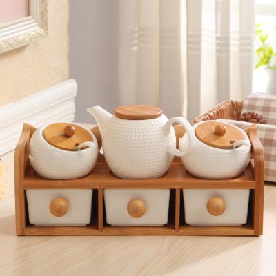 China New Year Sustainable Kitchenware Christmas Ceramic Bottle Jar Set Spice Seasoning Container With Bamboo Wood Shelf for sale