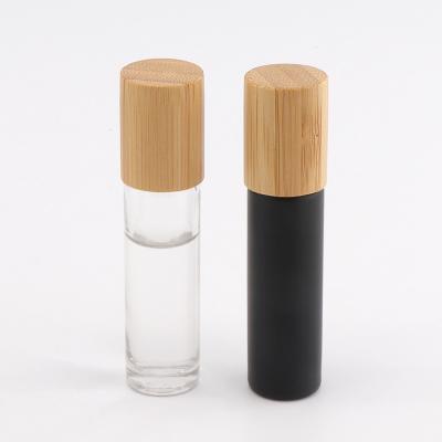 China Personal Care 5ml 10ml Matte Black Frosted Clear Glass Essential Oil Roll On Bottle With Bamboo Lid for sale