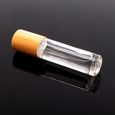 China Personal Care 5ml 10ml Matte Black Clear Glass Bottle Essential Oil Rollball Perfume Bottles With Bamboo Lid for sale