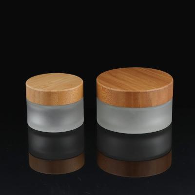 China 1OZ 2 Ounce 100ml 30ml Personal Care Cosmetics Matte Black Containers Packaging Body Cream Glass Cosmetic Jar With Bamboo Wooden Lid for sale