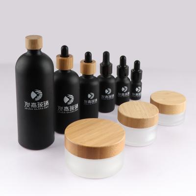 China Personal Care In Stock 15g 30g 50g 100g Frosted Essential Oil Sample Glass Bottle 30ml 50ml 100ml Glass Jar Bamboo Lid for sale