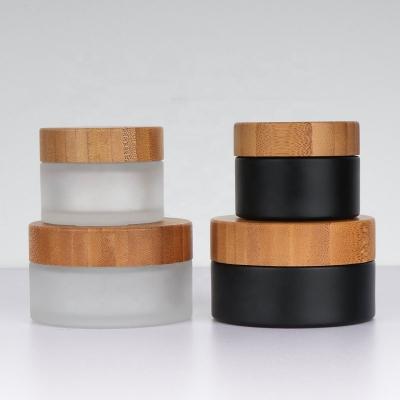 China Personal Care New Arrive Small Bottle 50g 100ml Essential Oil 30ml Dropper Glass Jars 50ml Black Bamboo Frosted Lid for sale