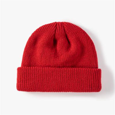 China COMMON Custom Logo Solid Color Skiing Warm Running Thick Knit Leather Winter Beanie Bowler Hat for sale