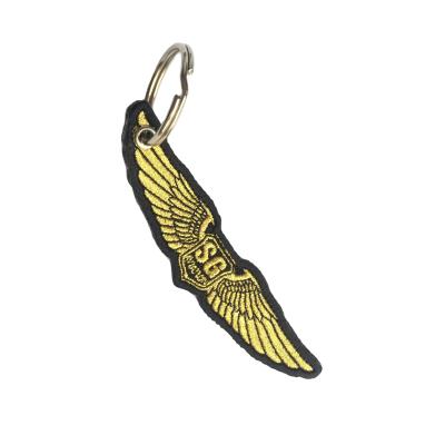 China Custom Promotion Gift Logo Double Sided Gold Wing Key Fob Flag Spray Key Tag Embroidered Key Chain for sale