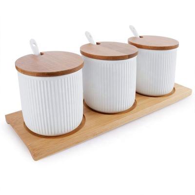 China Sustainable Popular Ceramic Kitchenware 3pcs Spice Jar Set With Bamboo Tray for sale