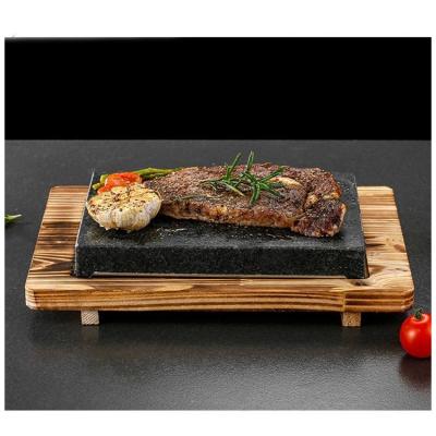 China Sustainable Cast Stone Steak Plate With Wooden Base Cooking Stone Complete Set Lava Hot Steak Stone Plate for sale