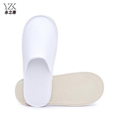 China Exquisite Disposable Hotel Amenities Hotel Slipper 100% cotton waffle embroider close Toe slippers unisex exclusive for hotels spa embroidery for sale