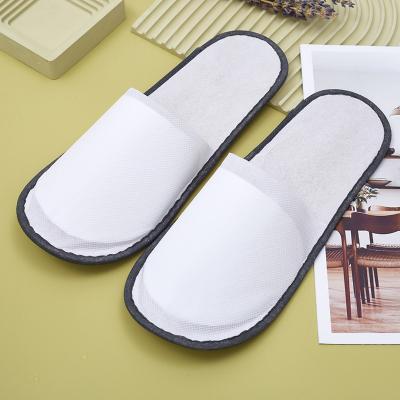 China Exquisite Disposable Hotel Amenities Cheap custom logo customised spa non-woven fabric material disposable hotel bathroom slippers for sale