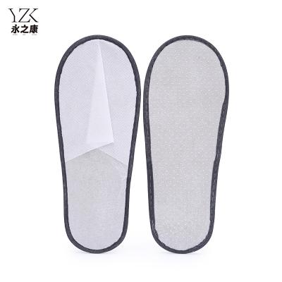 China Exquisite Disposable Hotel Amenities Nonwoven Fabric Disposable Slipper Cheap Price Hotel Room Guests Spa Non Woven Slippers for sale