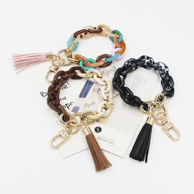 China Easy Wrist Button Tassel Alloy Bag Accessories Resin Key Chain Round Metal Key Pendant For Gift for sale