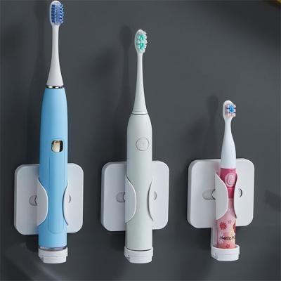 China Gravity Induction Sustainable Adjustment Electric Toothbrush Storage Rack Automatic Telescopic Bathroom Toothbrush Holder for sale