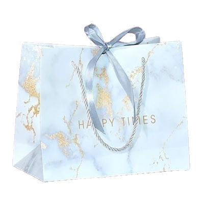 China Design handmade luxury paper bag with logo printing custom large purple paper cosmetic gift bag for guests for sale