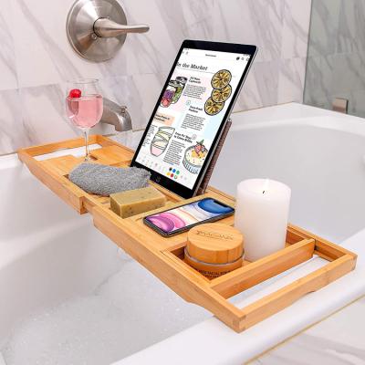 China Sustainable Wooden Bamboo Bath Tray Bath Caddy with Extend Side Wine Glass Stand and Phone Holder for sale