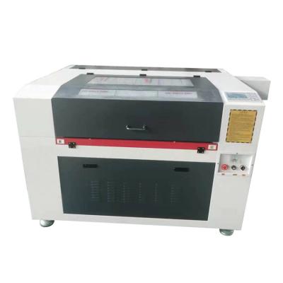 China Engraving And Cutting Industrial CO2 Laser Cloth Cutter Fabric Leather Cutting Machine 6040 for sale