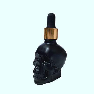 中国 Luxury high quality personal care skull shape glass dropper bottles with cheap price 販売のため