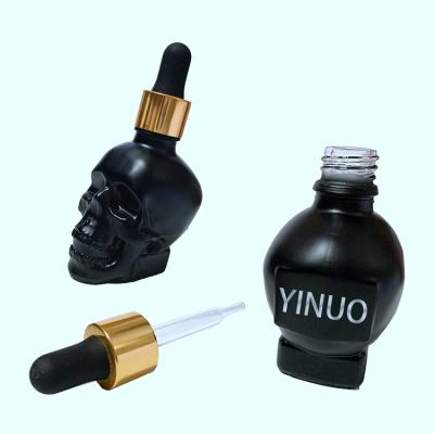 China Cosmetic high quality luxury skull shape glass dropper bottles with cheap price Te koop