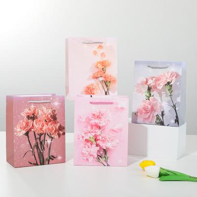 China Recycled Materials die cut branded paper shipping bag luxury with logo custom print white  cheap wholesale price mothers tulips butterflies dancing for sale