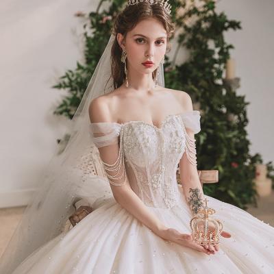 China New Lvory Wedding Dresses Luxury Anti-Static Boat Neck Short Tassels Sheath Beadings Crystal Applique Off Shoulder Bride Dresses Elegant for sale