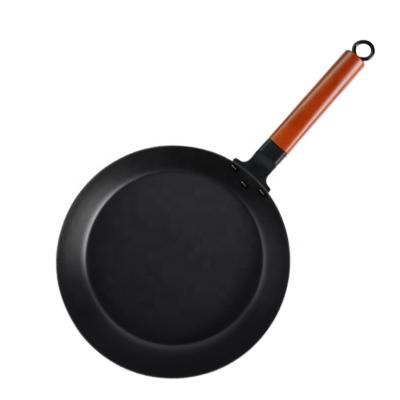 China Minimalist Custom Kitchen Use Cookware Carbon Steel Heat Resistant Frying Pan With Wooden Handle for sale