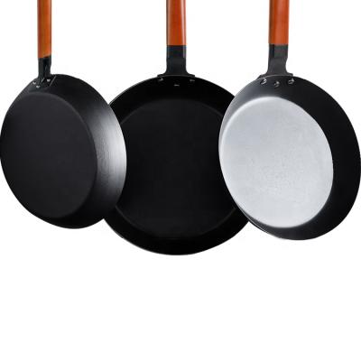 China Minimalist Multifunctional Carbon Steel Frying Pan Nonstick Nitriding Pan With Wooden Handle for sale