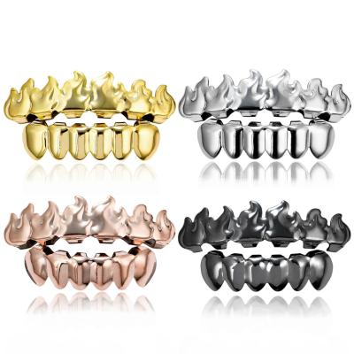 China Nickel Free Lead Free Body Jewelry Hip Hops Real Gold Plated Fire Shape Teeth Grillz Top & Bottom Teeth Grills Set For Punk Men for sale