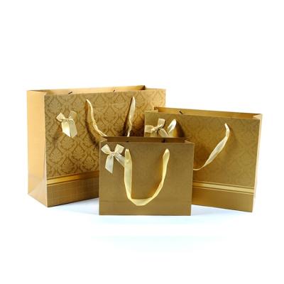 China Recyclable Custom Luxury Gold Jewelry Shopping Apparel Wrapping Paper Gift Bags With Ribbon Handle for sale