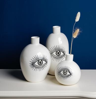 China Minimalist Nordic Creative Crafts Flower Arragement Ceramic Eye Hand Painting Designs Living Room Human Eyes Whiteware Home Ceramic Vase for sale