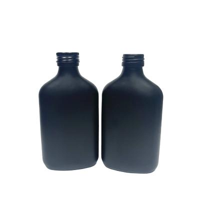 China 200ml Beverage Flask Matte Black Design Liquor Glass Bottle With Black Cap for sale