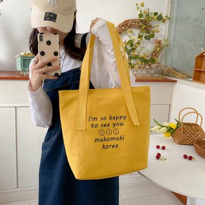 China 2022 Unique Large Capacity Handbag Ladies Canvas Waterproof Cute Smiling Custom Shoulder Bags for sale