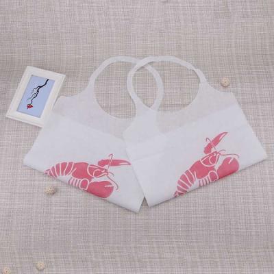 China Disposable nonwoven apron printing OEM waterproof aprons pe crab disposable nonwoven paper bib for restaurant for sale