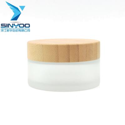 China OEM/ODM cosmetic cream jar/100g bamboo lid wood glass jar for skin care use for sale