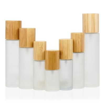 China 30ml 50ml 100ml 120ml 150ml cosmetic glass bamboo lotion pump bottle with bamboo lid for cosmetic for sale