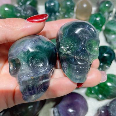 China China 2 Inch High Quality Natural Hand Carved Rainbow Fluorite Quartz Skulls Mini Gemstone Crystal Skulls For Healing for sale