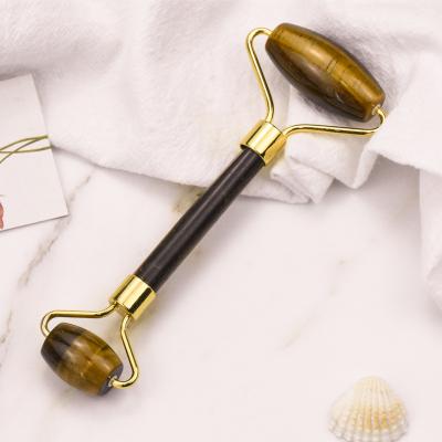 China Hot Selling Tiger Eye Jade Roller Two Whitening Heads Yellow Gold Metal Jade Facial Roller Handle for sale