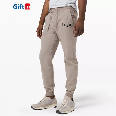 China Custom Anti-Wrinkle Male Men's Slim Fit Plus Size Beige Logo Pocket Tapered Skinny Bodysuit Sweatpants for sale