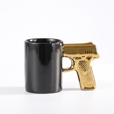 China Viable Creative Ceramic Gold And Silver Coffee Drinkware 3D Pistol Grip Mug Personality Modeling Cup Color Luster Mug for sale