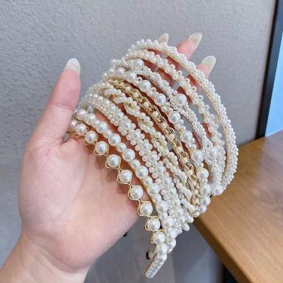 China 2021 Sexy luxury daily wear white pearl beaded headband women pearl bow hair accessories handmade elastic headband for girls for sale