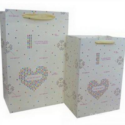 China Security Printed Art Paper Wholesale Fancy Gift Bags for sale