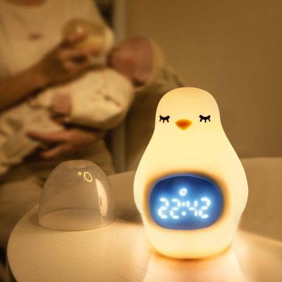 China Cartoon YIZHI Smart Wake Up Trainer Penguin Digital Pendulum Children Baby Sleep Alarm Clock with Led Night Light for Kids Room for sale