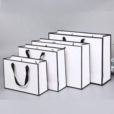 China Handmade custom luxury clothing retail bag packing bolsas de papel pink shopping bag gift packaging paper bags with handles for clothes for sale