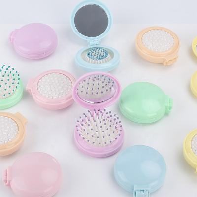 China Wholesale Cute Folding Enlargement Brush Hair Girl Travel Comb Portable Makeup Massager Enlargement Mirror Styling Tools Mini Pocket Mirror for sale