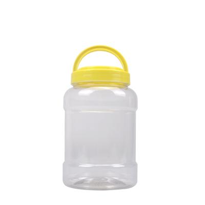 China Household Products 1000ml PET Plastic Jar Honey Pickles Jar With Handle Lid for sale