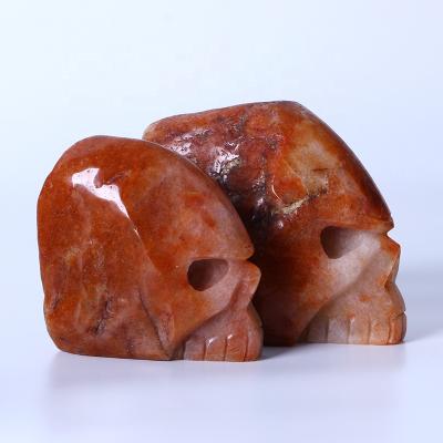 China Wholesale Europe Natural Folk Crafts Red Quartz Skull Hand Carved Skulls Healing Stones For Home Decoration for sale